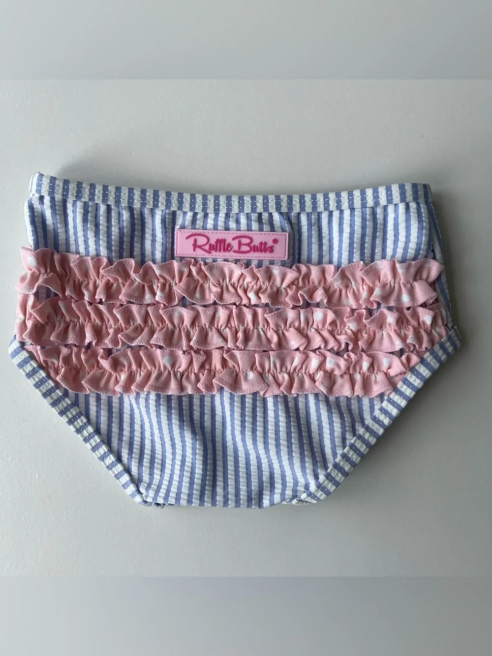 RuffleButts Blue Seersucker Two-Piece Swimsuit with Pink Polka Dot Ruffles